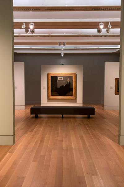 Gallery still for Exhibition On Screen: James McNeill's Whistler — a framed portrait facing a bench, from Jam Jar Cinema.